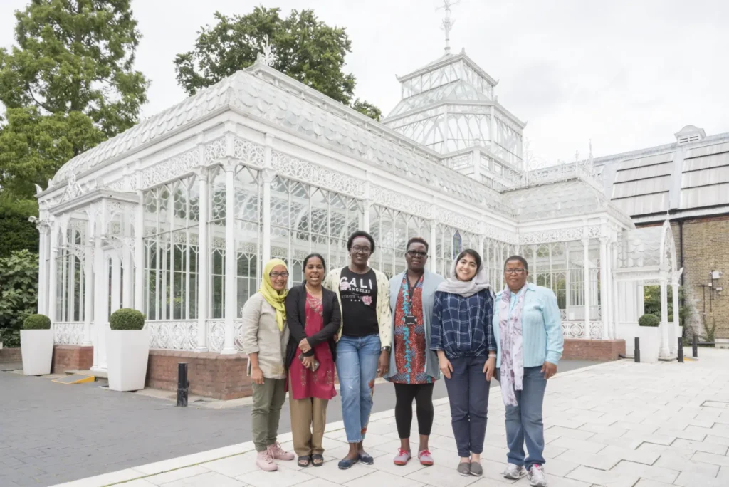 6 ITP fellows stand outside the greenhouse at Horniman Museum