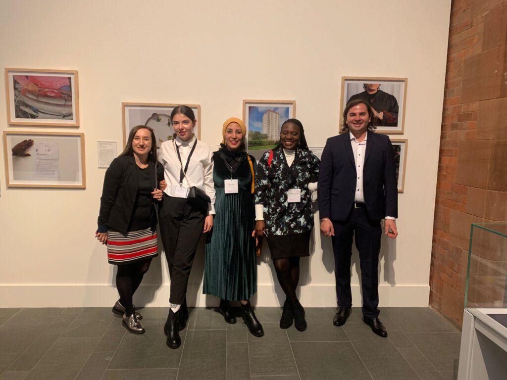 ITP fellows stand for a group photo in front a museum display