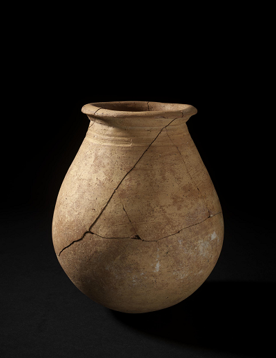 Wheel made bottle with a rounded base.