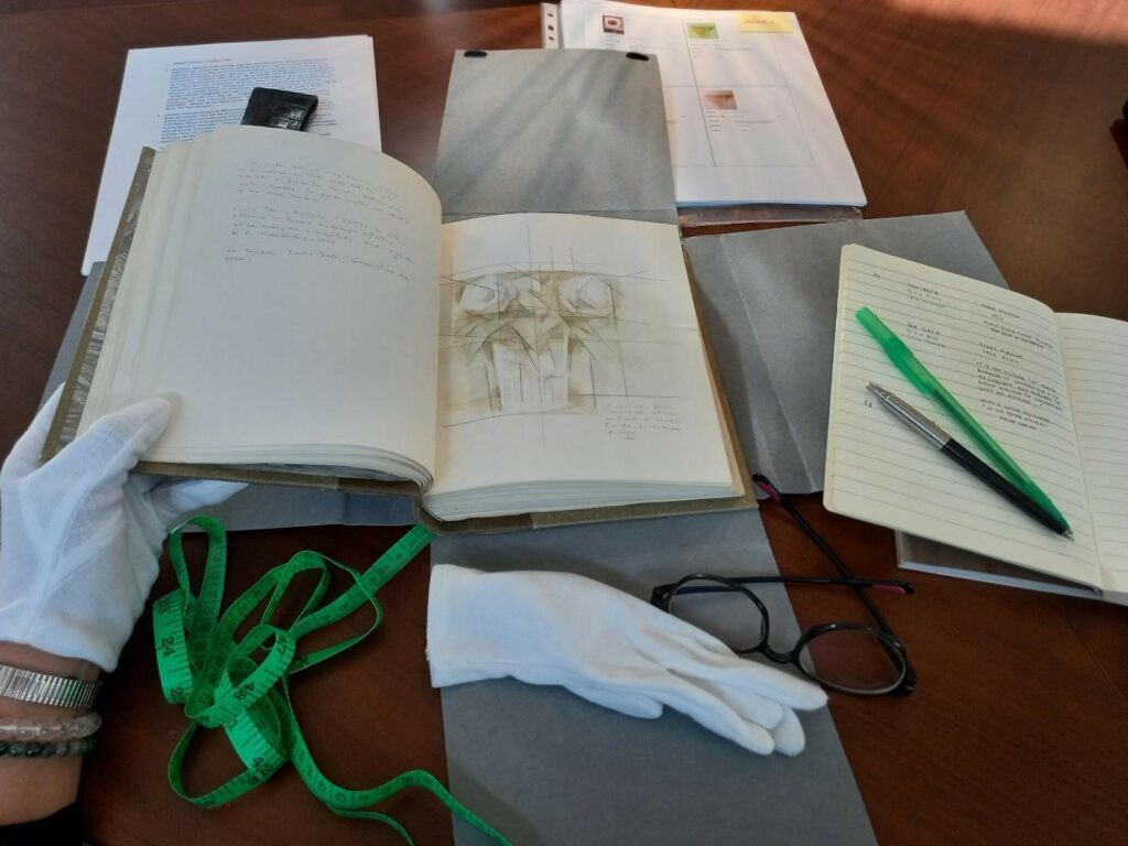 Opened book with sketches on the pages.