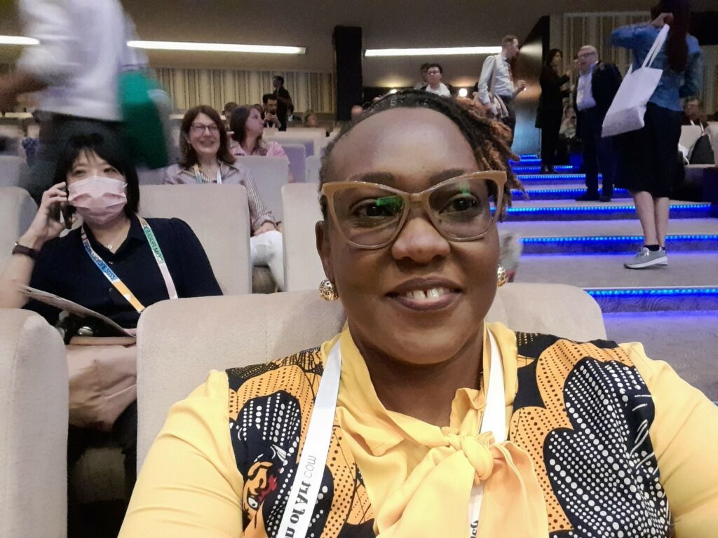 Beimote takes a selfie in a lecture hall at the ICOM 22 conference