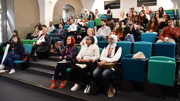 People sitting in a lecture theatre.