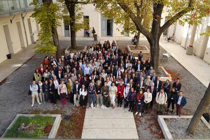 Large group photo outside in a courtyard