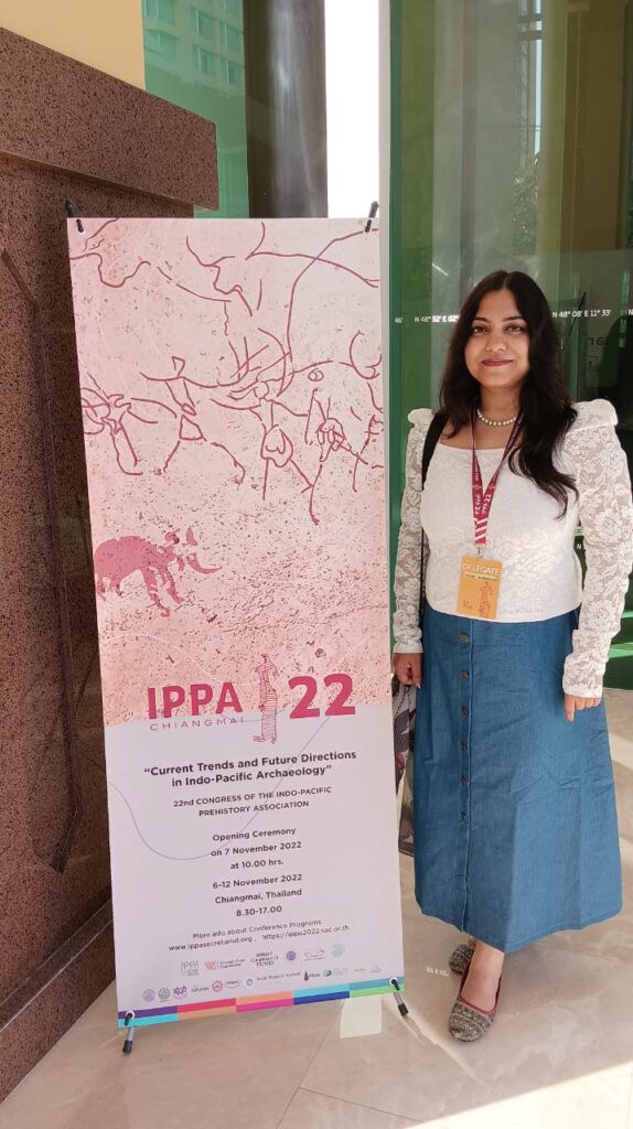 Vishi Upadhyay standing next to a sign for IPPA22