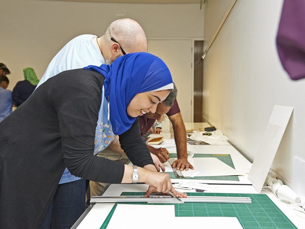 Hadeer working at a table during an ITP practical session.