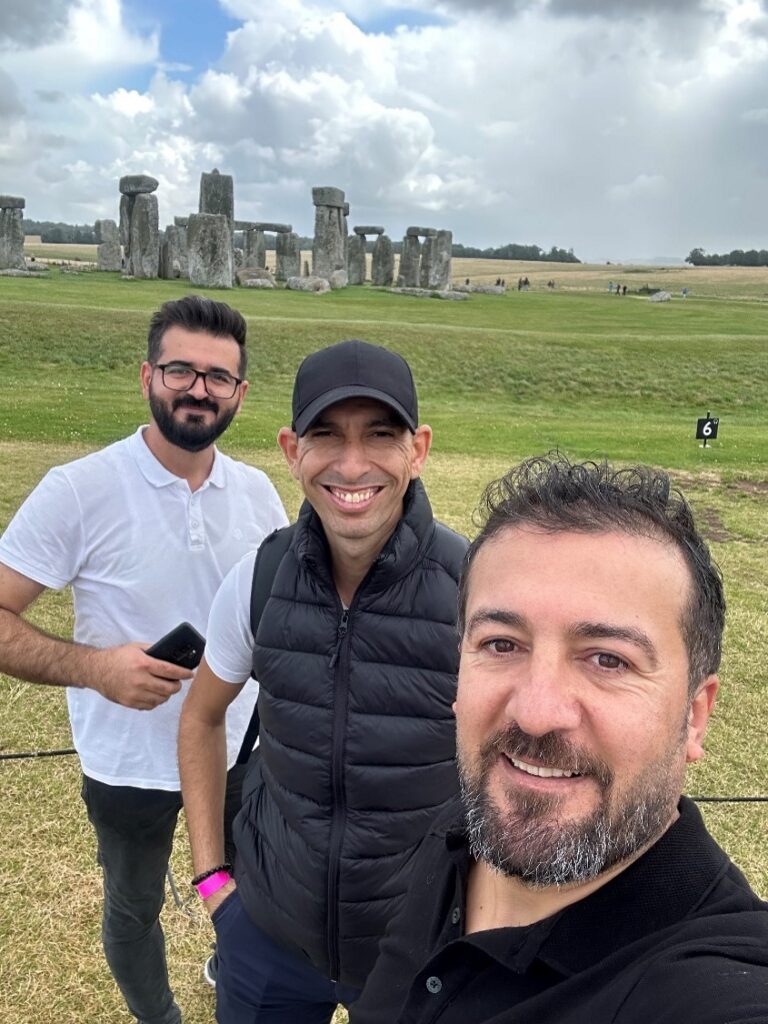 (L-R) Twana Mamand, Aymen Chihaoui, and Ali Demirkiran in front of Stonehenge.