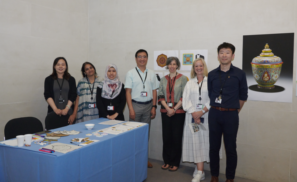 Asia department fellows and staff stand for a group photo with their object in focus project.