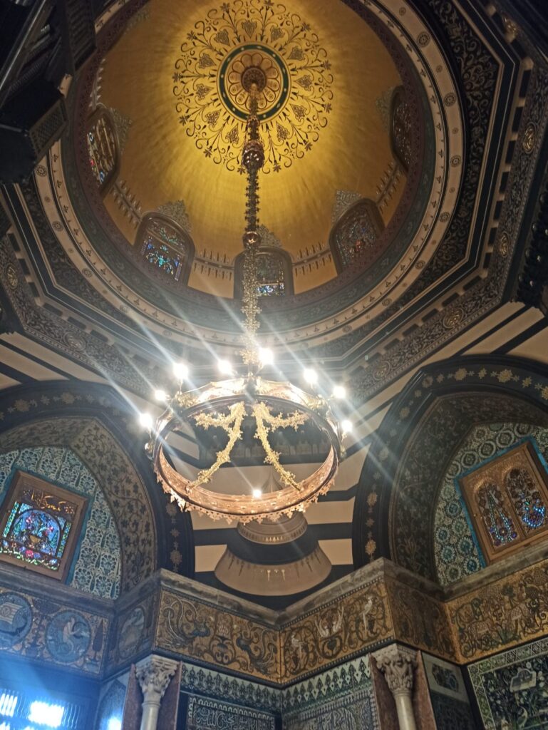 The gold domed ceiling inside Leighton House Museum, surrounded by gold and blue interiors inspired by Middle Eastern motifs. 