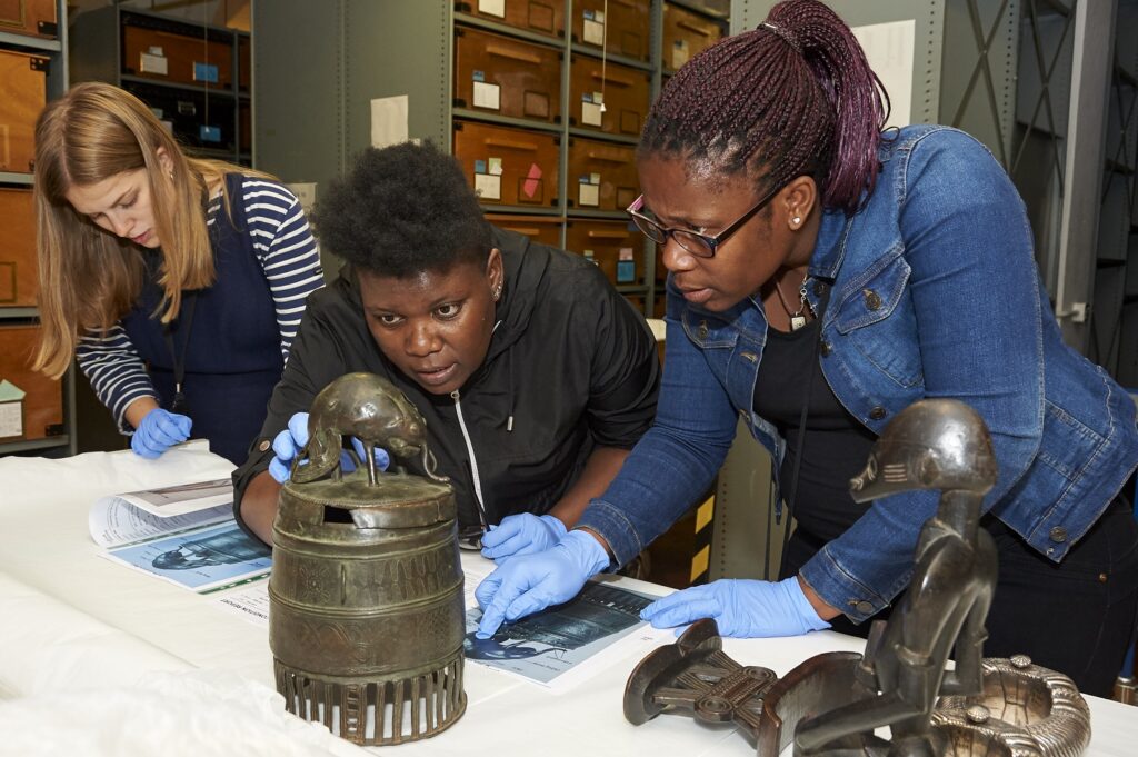 Getrude photographed during the ITP with another fellow looking at an oblect.