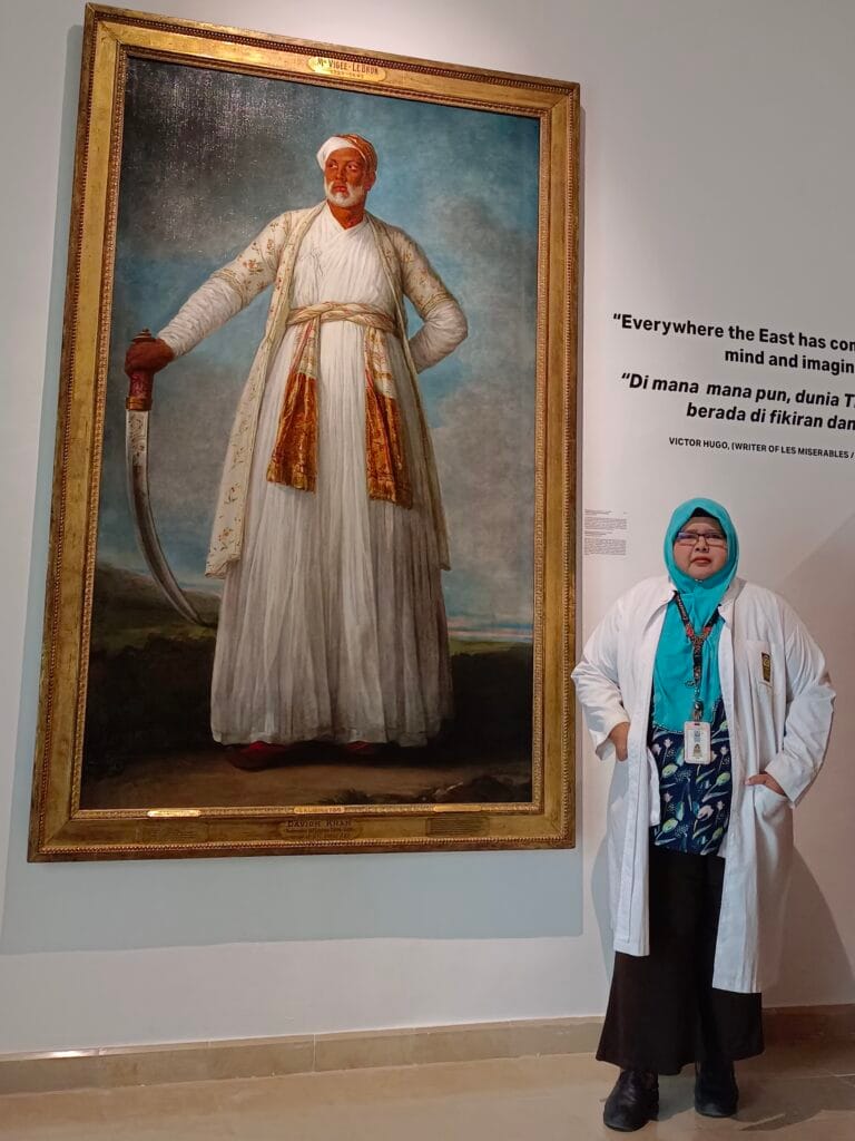 Rafidah standing next to Élisabeth Louise Vigée Le Brun’s portrait of Muhammad Dervish Khan.