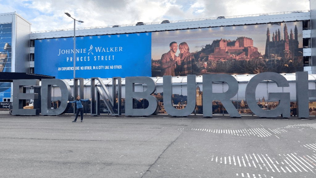 Rema standing in front of a huge 'Edinburgh' sign