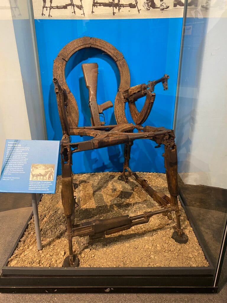 Photograph of a chair made from guns.