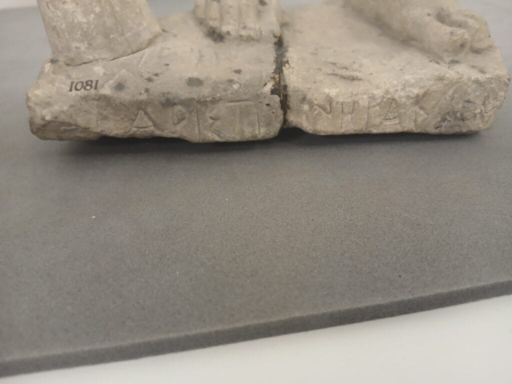 Photograph of an inscription on a stone statue.