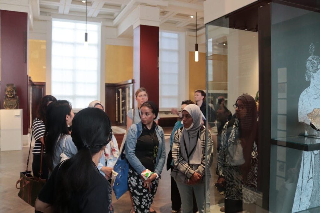 Photograph of a group of people in a museum gallery.