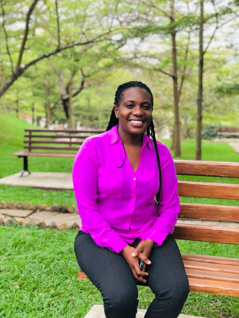Photograph of a woman sat on a bench.