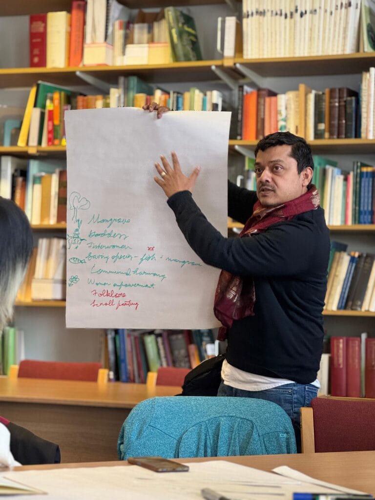 Photo of a man presenting a poster