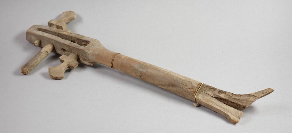 Fragment of a wooden lute. This is only the neck of the instrument, the body has not survived. The lute had four gut strings, the remains of which can still be seen around three remaining tuning pegs of the original four.
