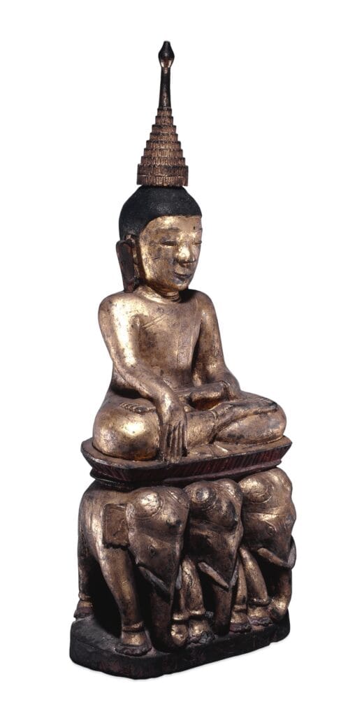 Figure. Image of the crowned Buddha seated on an three-elephant throne. Made of painted and gilded and lacquered wood.